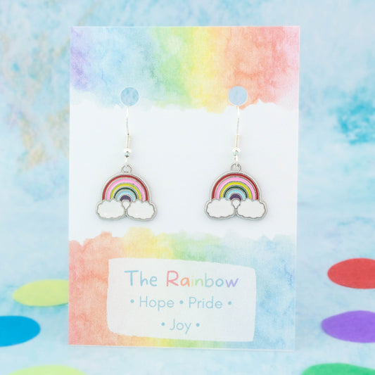 Silver Enamel Rainbow Charm Earrings backed onto a card with its meanings of hope, pride and joy.