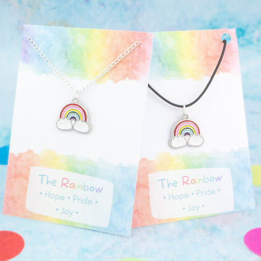 Silver enamel rainbow charm necklace available on either silver chain or black cord. Backed on a card with the meanings of hope, pride and joy.