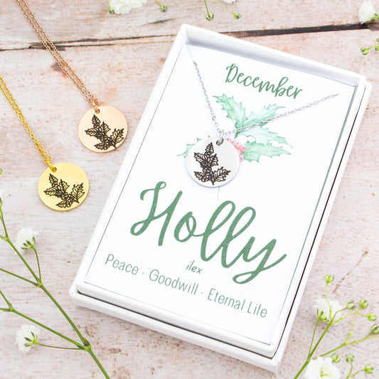 A beautiful birth flower necklace featuring December’s birth flower – Holly. The necklace is available in silver, gold or rose gold stainless steel and can be personalised with an engraving on the reverse.
