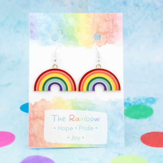 Big Enamel Rainbow Charm Earrings backed onto a card with its meanings of hope, pride and joy.