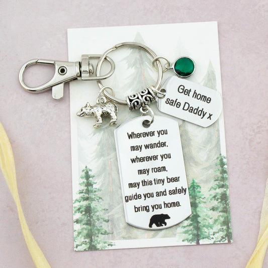 This shows the fully personalised travel Bear keyring which includes the silver Bear charm, the engraved quote tag which reads: “Wherever you may wander, wherever you may roam, may this tiny Bear guide you and bring you safely home” a birthstone and a mini engraved gift message tag. It also has a clasp to attach to a bag.