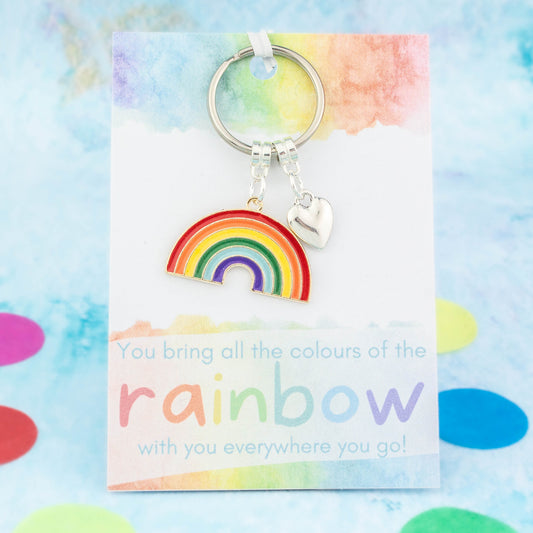 A big rainbow and heart charm gift keyring. It is backed onto a card that reads "You bring all the colours of the rainbow with you everywhere you go!"
