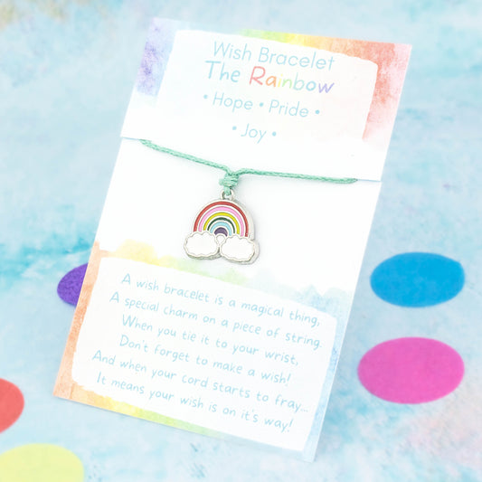 An enamel rainbow charm bracelet. It's a wish bracelet which means it is a charm on a cord that you tie to your wrist. When your cord wears through your wish is said to come true. It comes backed on a card with the symbolic meanings of the rainbow - hope, pride and joy.