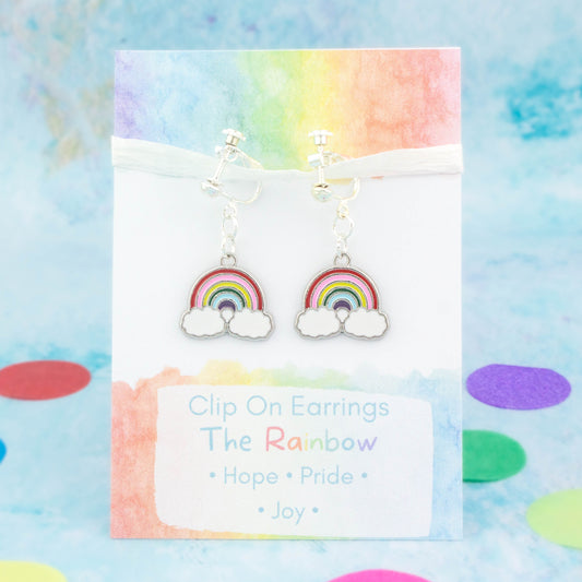 A pair of rainbow flower clip on earrings. It's backed onto a card that says the symbolic meanings of the rainbow - hope, pride and joy.