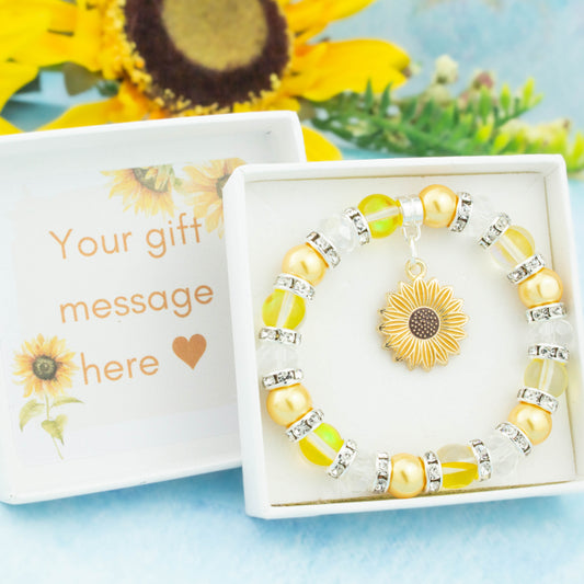 A sunflower charm bracelet made with yellow beads. It is in a personalised gift box.
