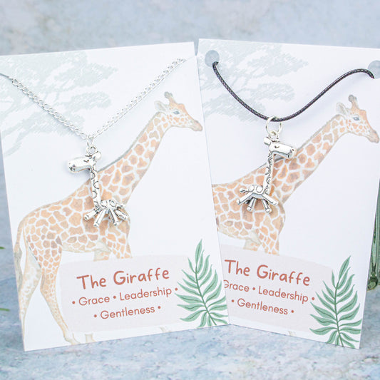 Silver giraffe charm necklace available on either silver chain or black cord.