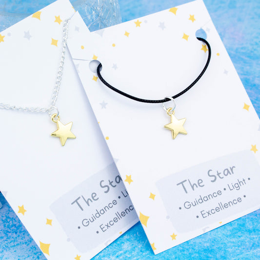 Gold star charm necklace available on either silver chain or black cord.