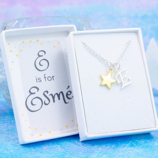 A silver chain necklace with a gold star pendant and initial charm. The gift box is personalised with the name of the recipient.
