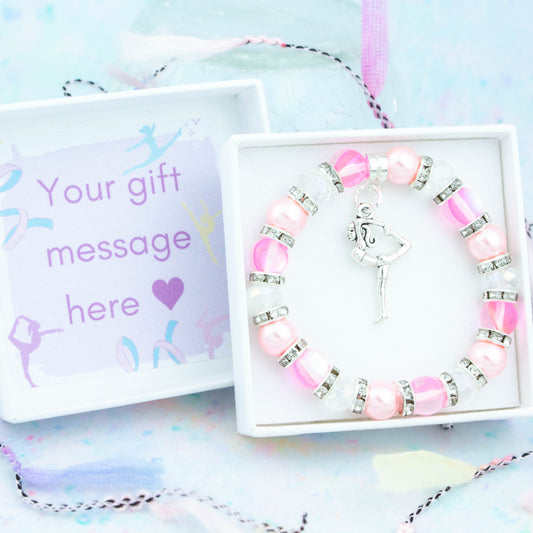 A gymnast charm bracelet made with pink beads. It is in a personalised gift box.