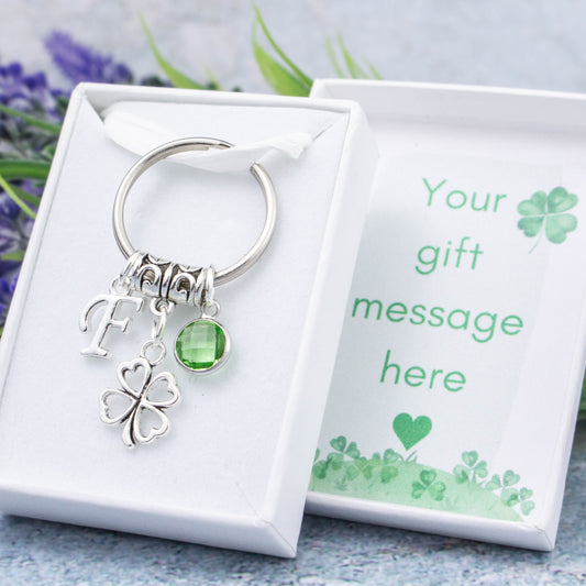 Silver four leaf clover charm keyring with an initial and birthstone. Presented in a gift box with a personalised message insert.