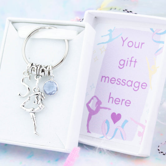 Silver gymnast charm keyring with an initial and birthstone. Presented in a gift box with a personalised message insert.
