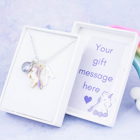 Enamel purple unicorn charm necklace with an initial and birthstone. Presented in a gift box with a personalised message insert.