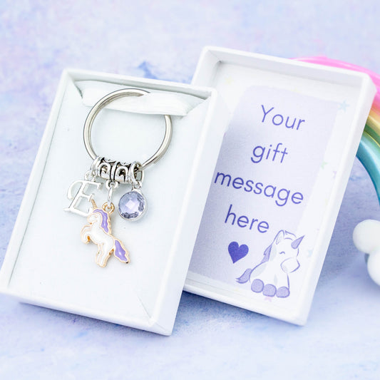 Purple unicorn charm keyring with an initial and birthstone. Presented in a gift box with a personalised message insert.
