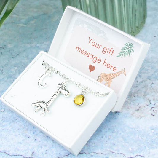Silver giraffe charm bracelet with an initial and birthstone. Presented in a gift box with a personalised message insert.