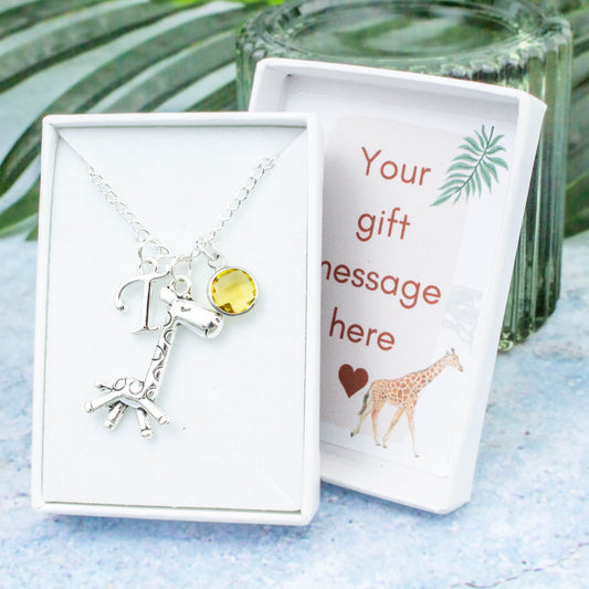 Silver giraffe charm necklace with an initial and birthstone. Presented in a gift box with a personalised message insert.