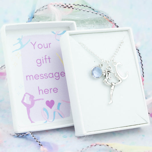 Silver gymnast charm necklace with an initial and birthstone. Presented in a gift box with a personalised message insert.