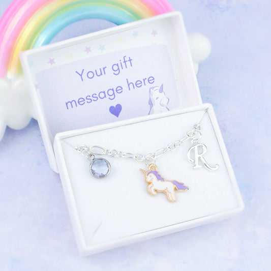 Enamel purple unicorn charm bracelet with an initial and birthstone. Presented in a gift box with a personalised message insert.