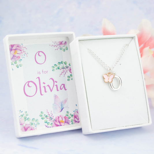 A silver chain necklace with a pink butterfly pendant and initial charm. The gift box is personalised with the name of the recipient.