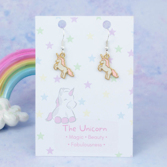 Enamel Pink Unicorn Charm Earrings backed onto a card with its meanings of beauty, magic and fabulousness