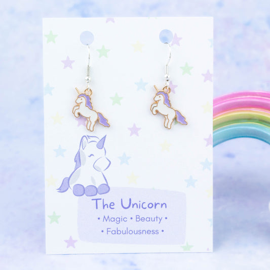 Enamel Purple Unicorn Charm Earrings backed onto a card with its meanings of beauty, magic and fabulousness