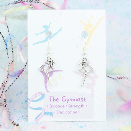 Silver 3D Gymnast Charm Earrings backed onto a card with its meanings of balance, strength and determination.