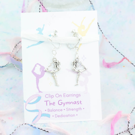 Gymnastics Clip On Earrings backed onto a card with its meanings of balance, strength and dedication.
