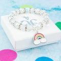 A silver and white rainbow charm bracelet with sparkly beads.