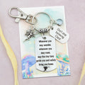 This shows the fully personalised travel Fairy keyring which includes the silver Fairy charm, the engraved quote tag which reads: “Wherever you may wander, wherever you may roam, may this tiny Fairy guide you and bring you safely home” a birthstone and a mini engraved gift message tag. It also has a clasp to attach to a bag. 
