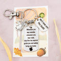 This shows the fully personalised travel squirrel keyring which includes the silver squirrel charm, the engraved quote tag which reads: “Wherever you may wander, wherever you may roam, may this tiny squirrel guide you and bring you safely home” a birthstone and a mini engraved gift message tag. It also has a clasp to attach to a bag. 