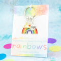 A rainbow sentimental gift. It is a keyring with three charms, a rainbow, umbrella and hope. The sentiment reads 
