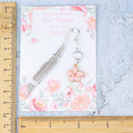 The measurements of the pink flower charm bookmark.