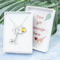 Silver giraffe charm necklace with an initial and birthstone. Presented in a gift box with a personalised message insert. 