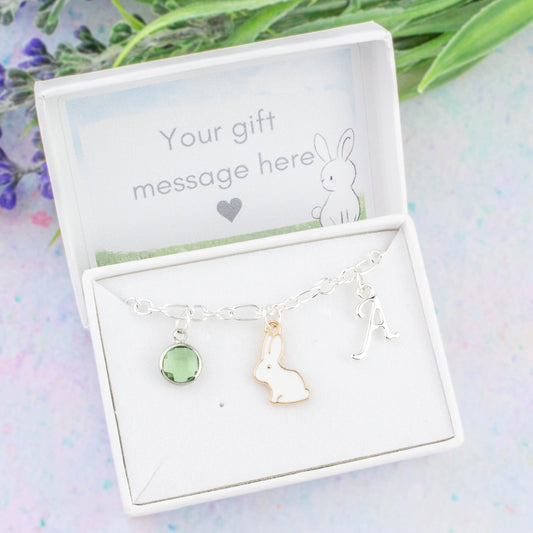 A personalised white rabbit charm bracelet. An initial and birthstone charm can be added and you can also add a personal gift message to the interior box lid.