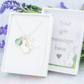 A personalised white rabbit charm necklace. An initial and birthstone charm can be added. It also comes in a gift box with your personal message printed inside the lid.