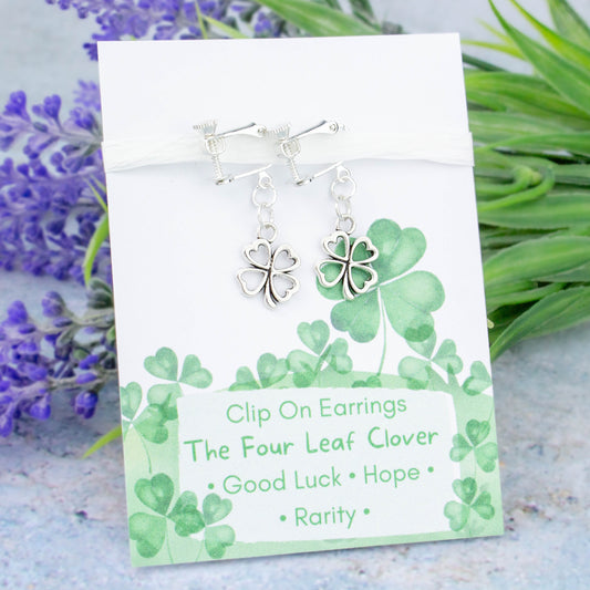 Four Leaf Clover Charm Earrings backed onto a card with its meanings of good luck, hope and rarity.