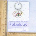 Unicorn birthday gift keyring against a ruler.