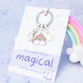 A keyring with three charms, a unicorn, a rainbow and a star. The quote on the backing card says 