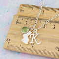 The measurements of the personalised white rabbit charm necklace shown against a ruler.